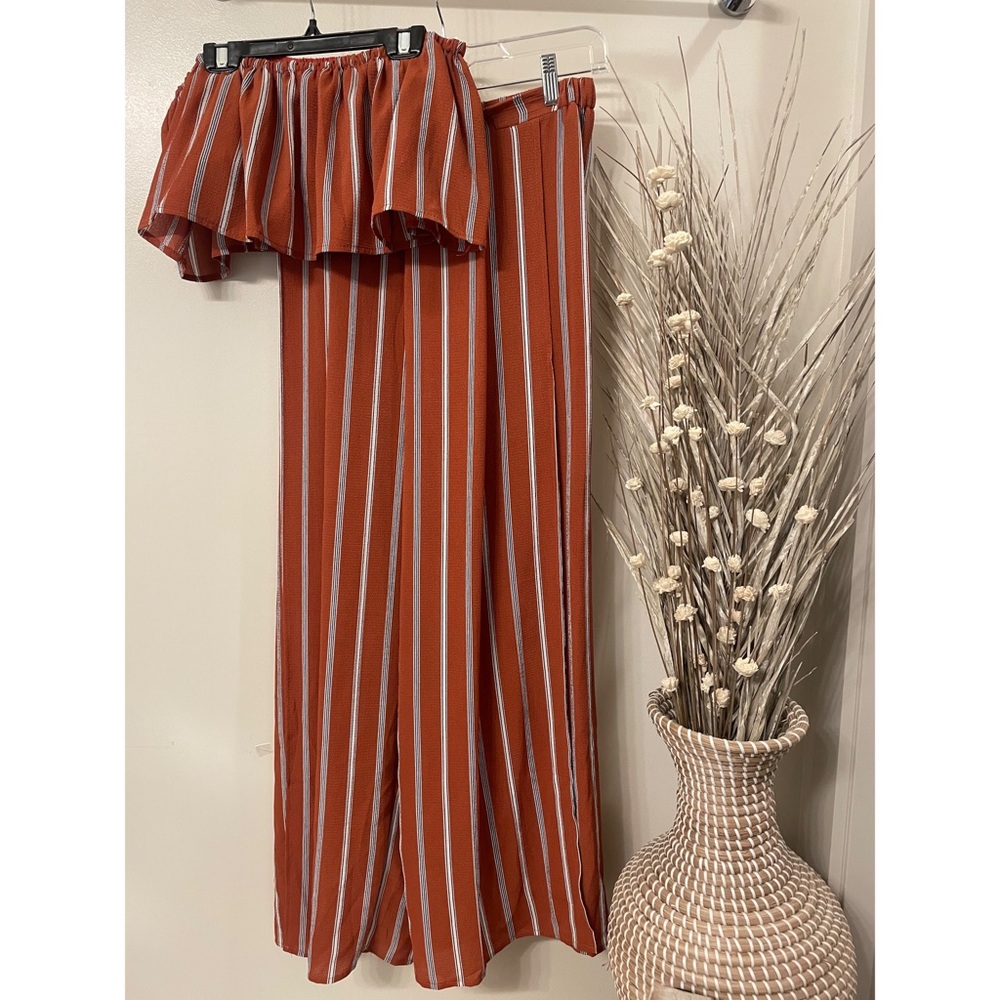 Like new. 2 piece jumpsuit. Orange with black stripes. Size medium.